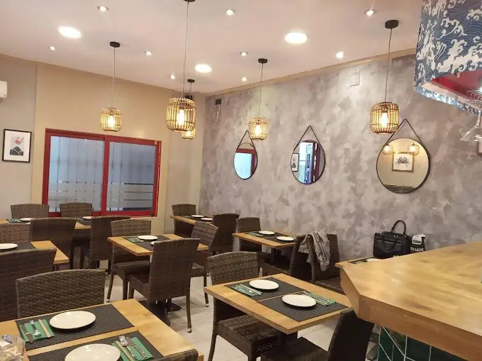The dining room: wooden tables, rattan lamps and round mirrors