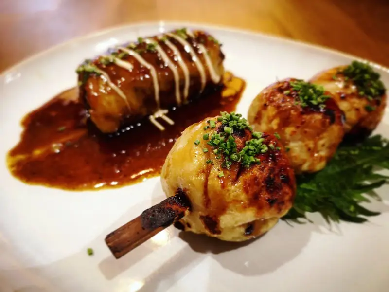 Glazed yakitori skewers on a white plate